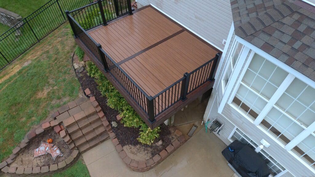 Brown deck with a black railing
