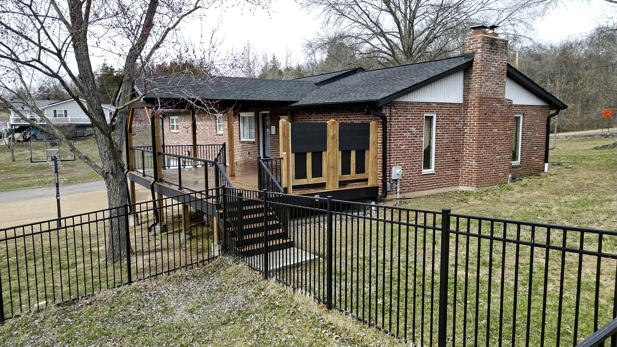 Covered deck and privacy screens seen from a fenced backyard