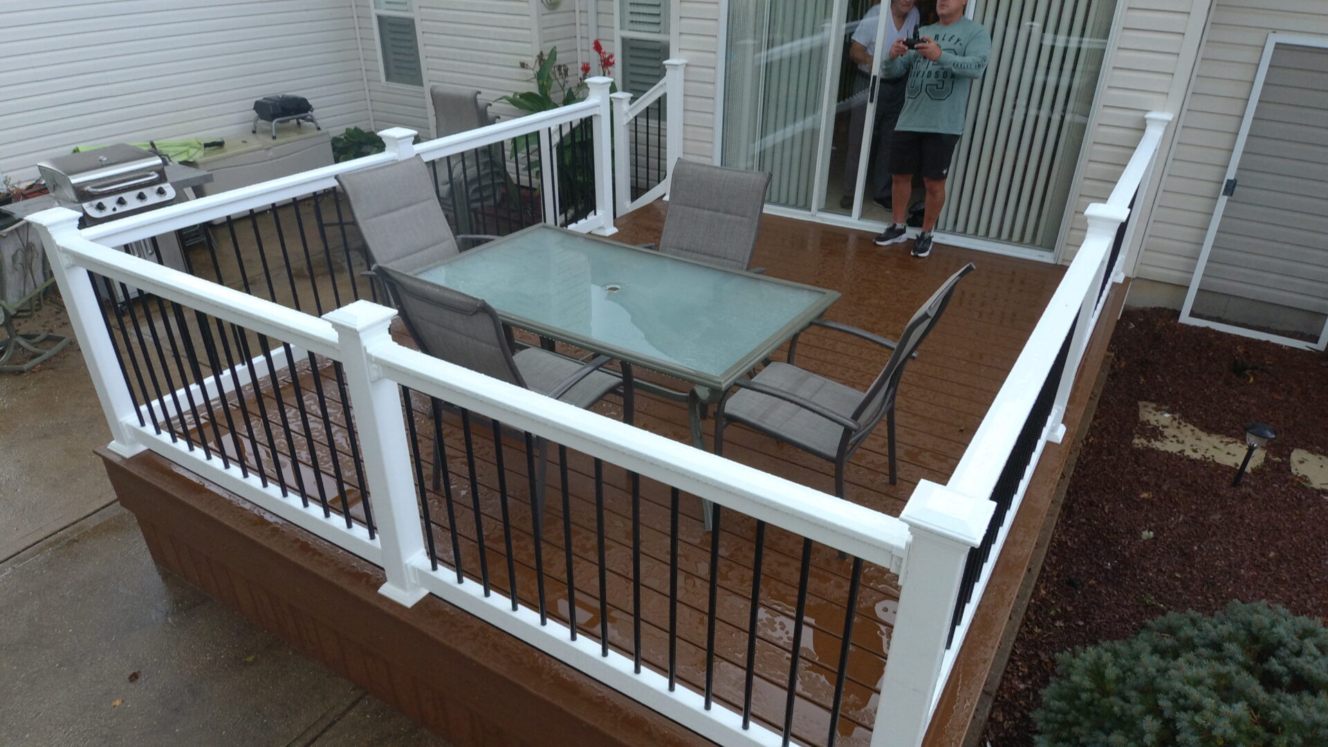 Deck with a white rail and black balusters