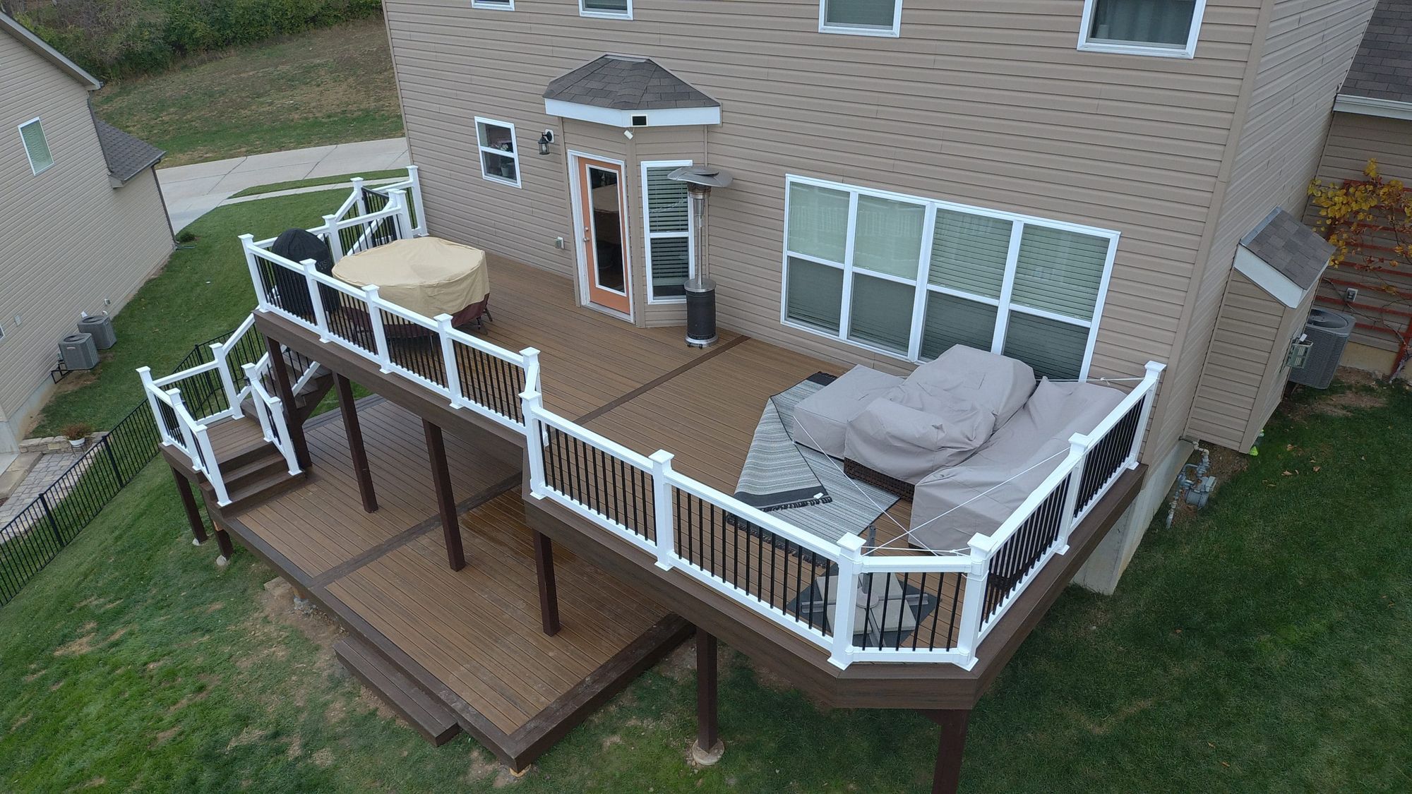 Two-tier deck with white rail built by Leach Construction