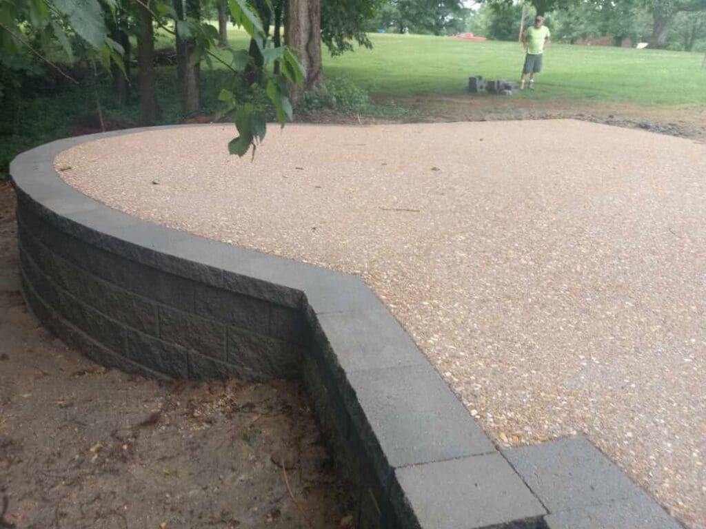 Curved retaining wall with gravel patio
