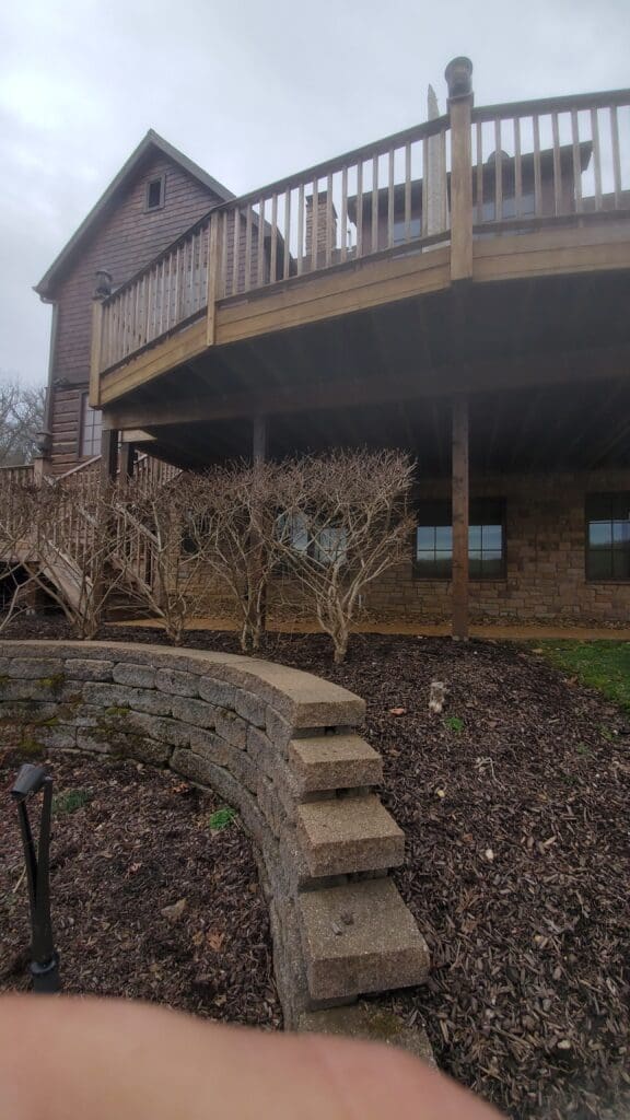 Elevated deck above a block retaining wall